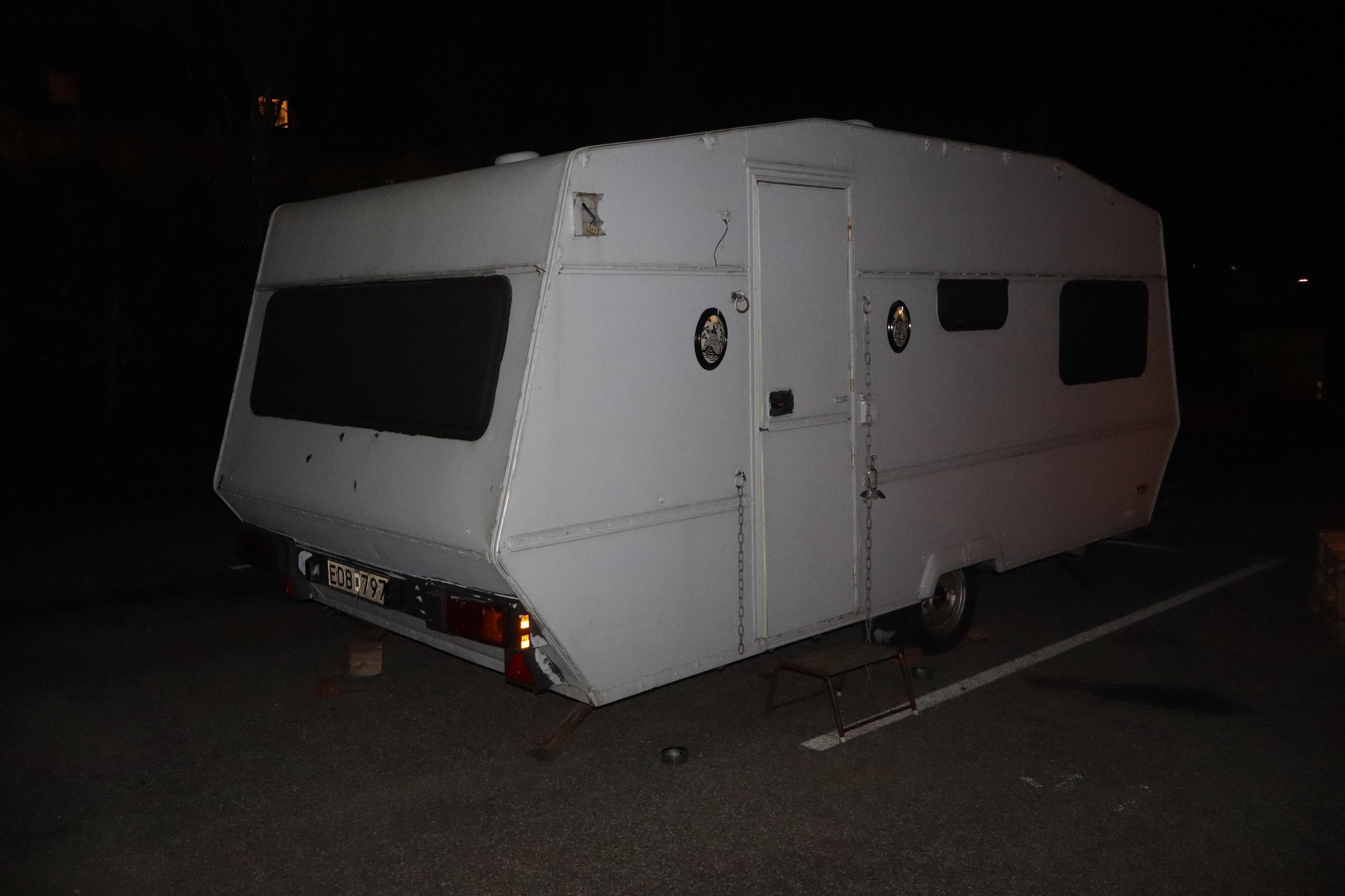 The white L.E.O.N. caravan photographed at night
